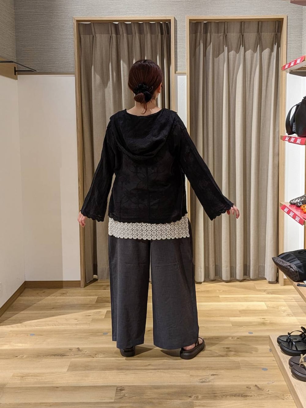 ブラック系のシャツ/ブラウス、ブラック系のショルダーバッグ、ブラウン系のサンダルを着用したレディースの夏コーディネートの2枚目の写真