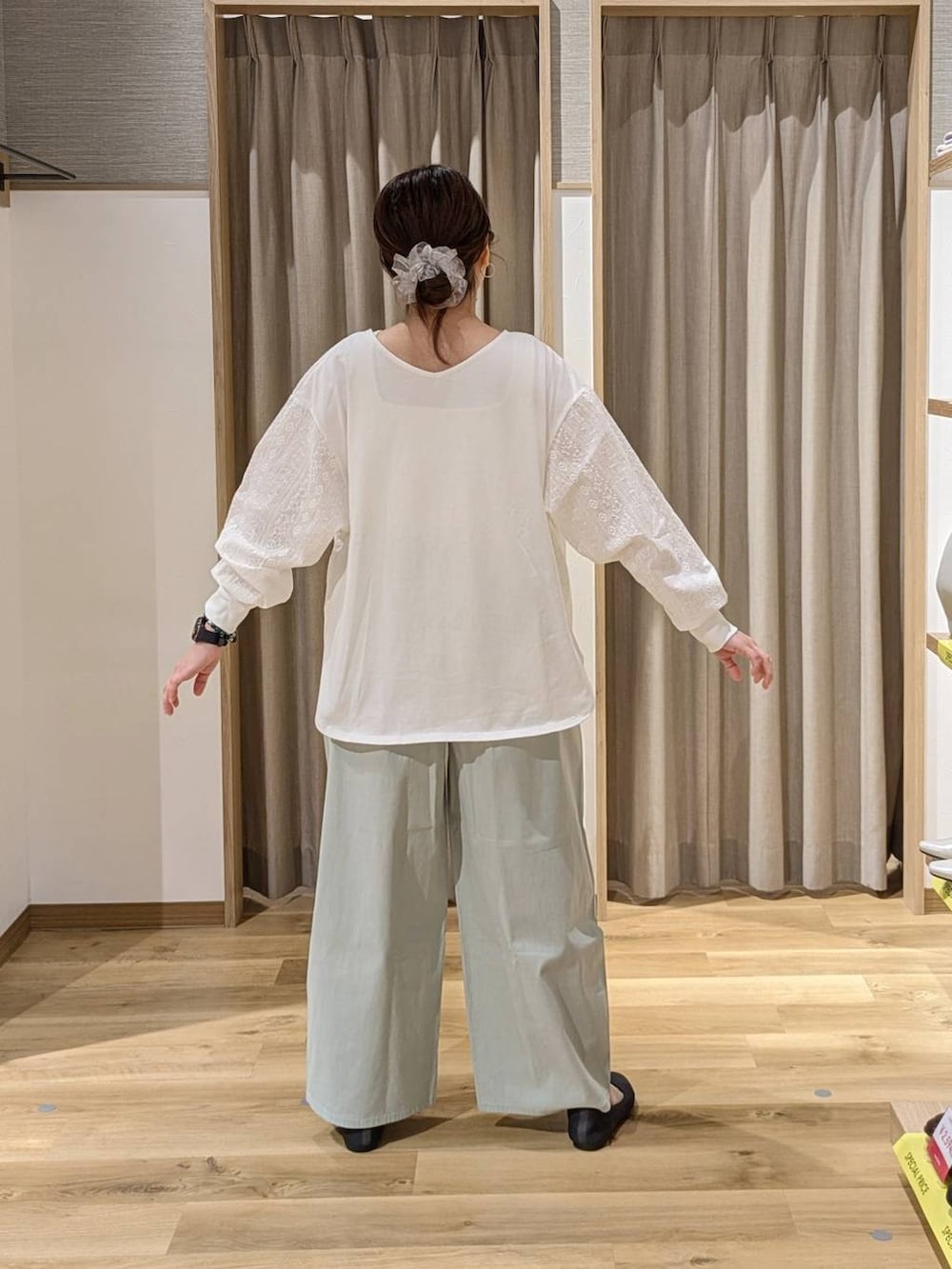 ブラウン系のショルダーバッグ、グレー系のパンプス、グリーン系のその他パンツを着用したレディースの春コーディネートの2枚目の写真