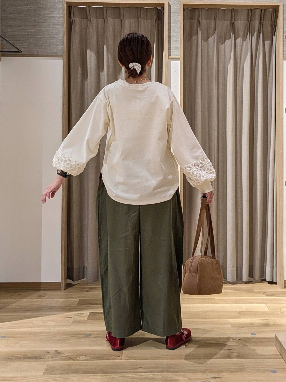 ブラウン系のショルダーバッグ、レッド系のその他シューズ、ホワイト系のTシャツ/カットソーを着用したレディースの秋コーディネートの3枚目の写真