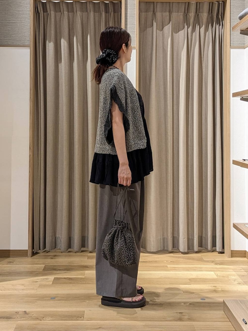 ブラック系のシャツ/ブラウス、グレー系のニット/セーター、ベージュ系のサンダルを着用したレディースの夏コーディネートの2枚目の写真