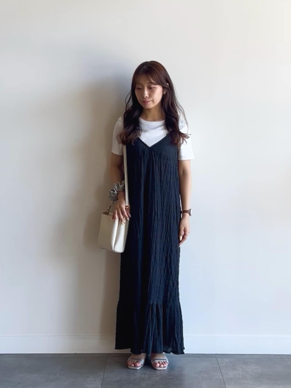 ホワイト系のTシャツ/カットソー、ブラック系のワンピース、ホワイト系のショルダーバッグを着用したレディースの夏コーディネートの2枚目の写真