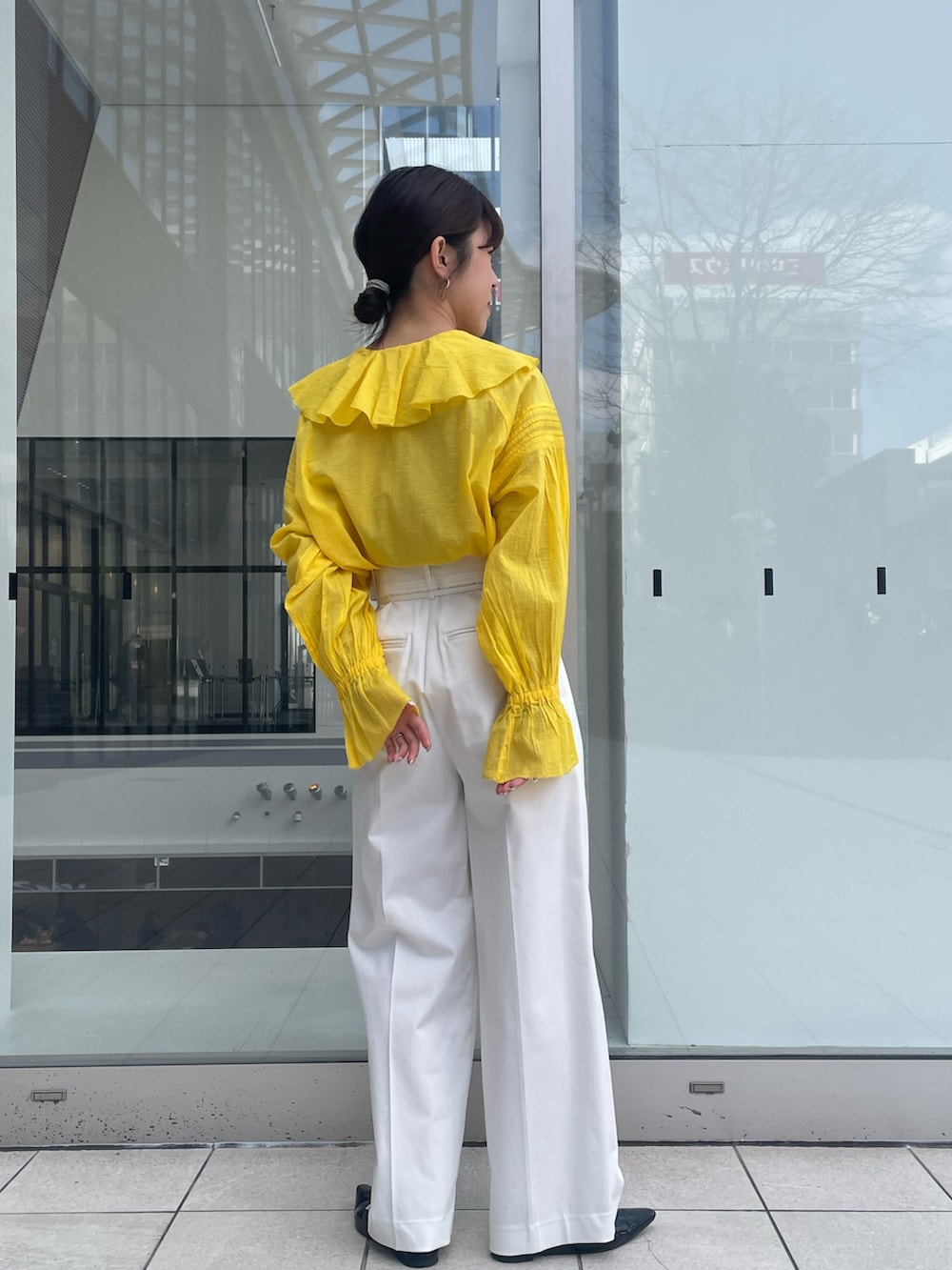 イエロー系のシャツ/ブラウス、ホワイト系のその他パンツを着用したレディースの春コーディネートの2枚目の写真
