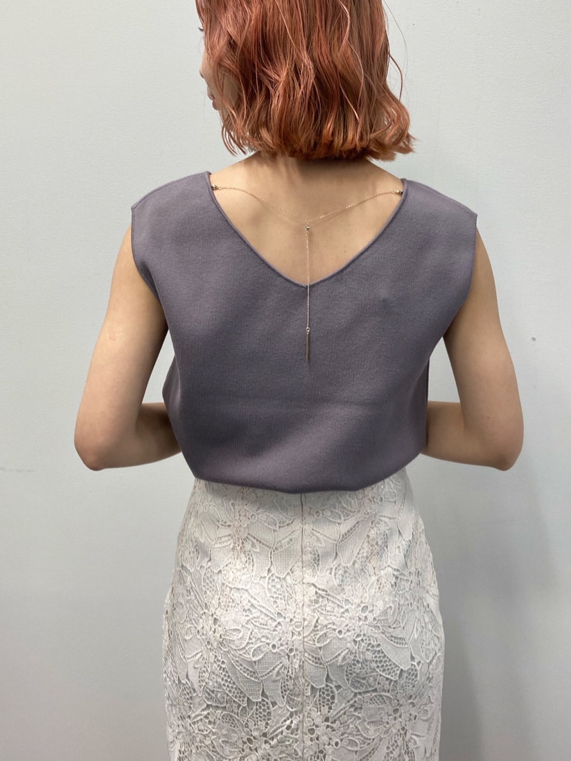 ホワイト系のスカート、ブラウン系のニット/セーター、ベージュ系のサンダルを着用したレディースの春コーディネートの2枚目の写真