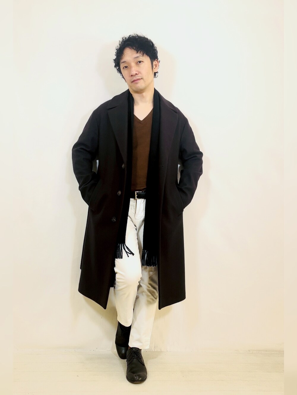 ブラウン系のジャケット/アウター、ホワイト系のスラックス、ブラック系のドレスシューズを着用したメンズの冬コーディネートの5枚目の写真