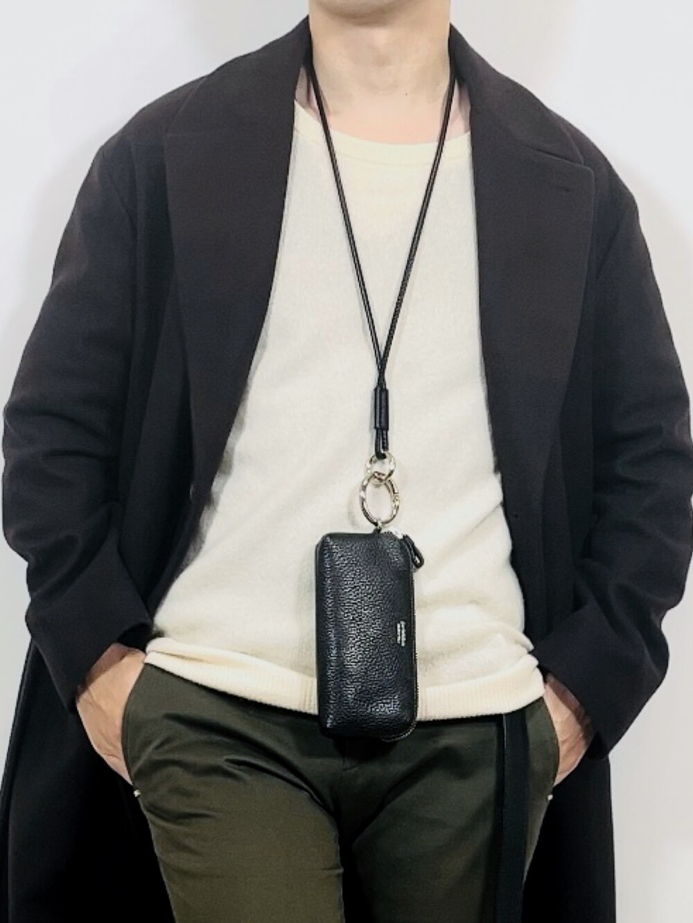 グリーン系のスラックス、ブラウン系のジャケット/アウター、ブラック系のスニーカーを着用したメンズの冬コーディネートの2枚目の写真