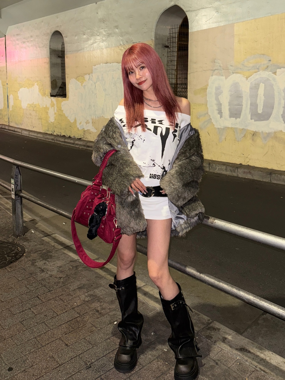 グレー系のダウンジャケット/コート、ブラック系のブーツ、ホワイト系のワンピース/ドレスを着用したレディースの冬コーディネートの2枚目の写真