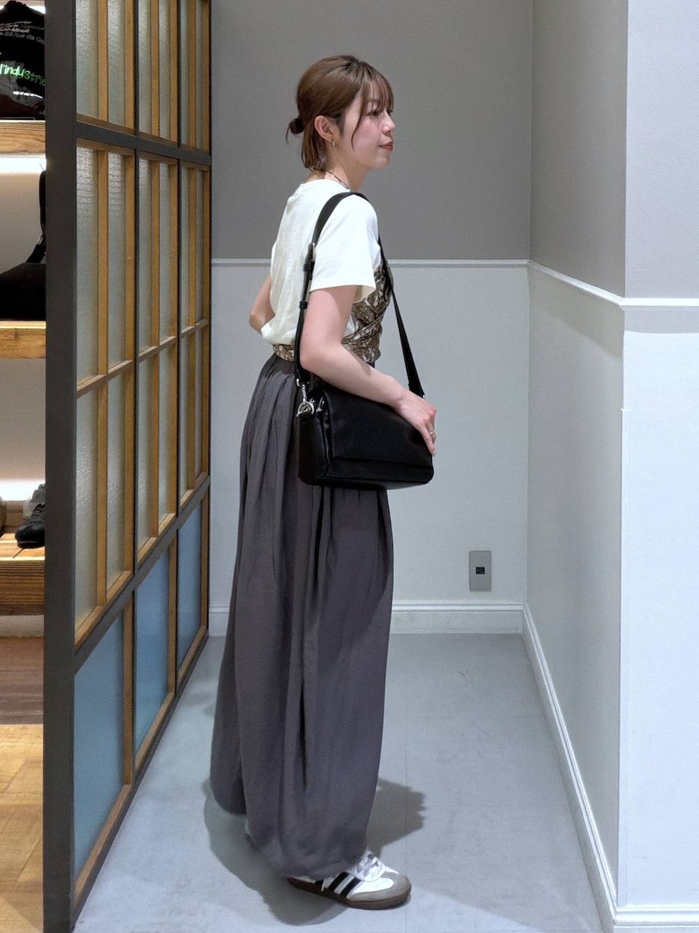 ブラック系のショルダーバッグ、グレー系のその他パンツ、ホワイト系のTシャツ/カットソーを着用したレディースの春コーディネートの3枚目の写真