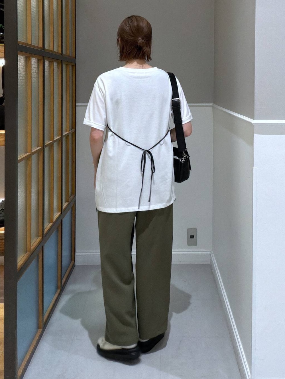 ブラック系のショルダーバッグ、グリーン系のその他パンツ、ホワイト系のサンダルを着用したレディースの春コーディネートの3枚目の写真