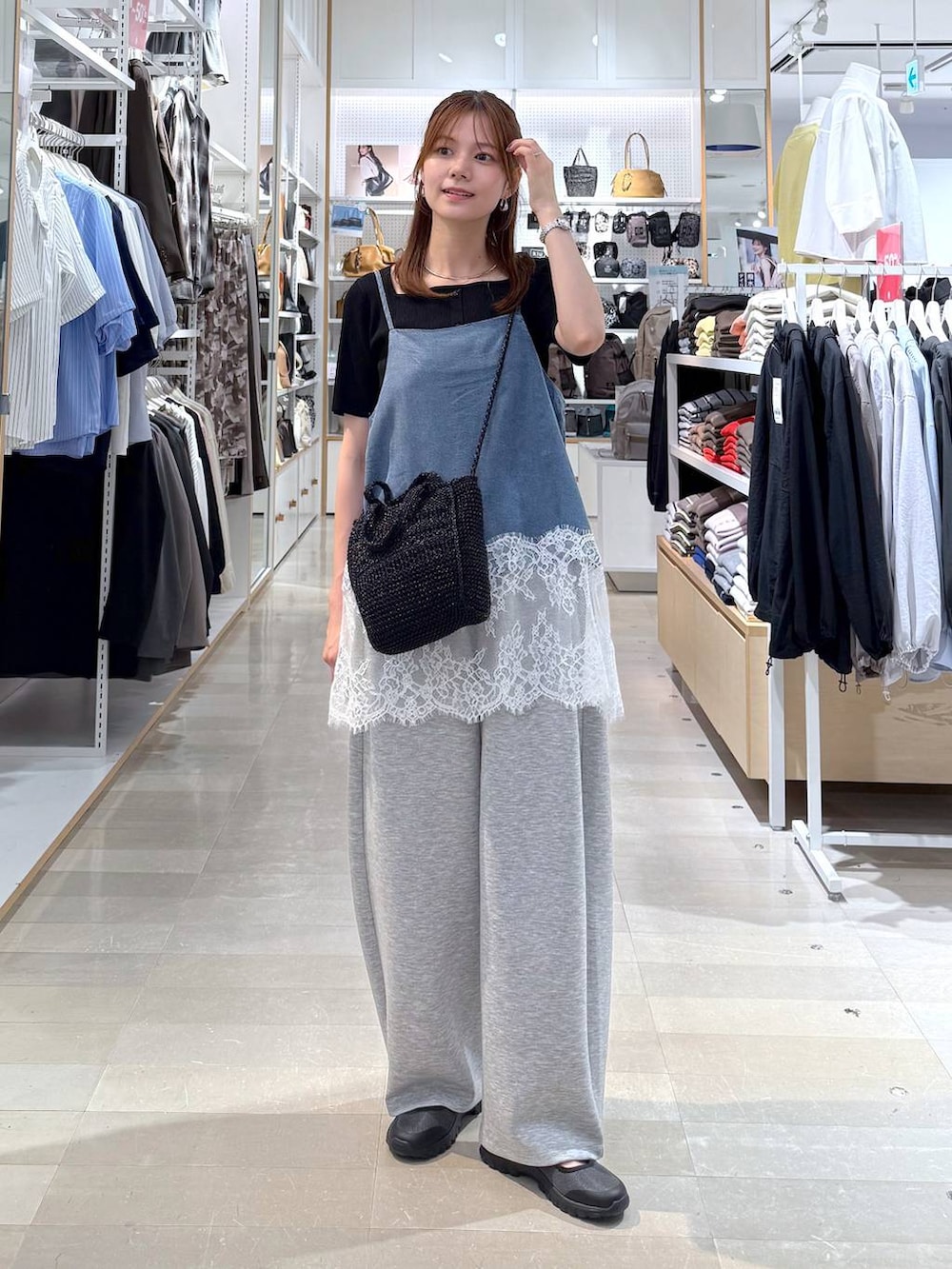 グレー系のスニーカー、グレー系のその他パンツ、ブラック系のクラッチバッグを着用したレディースの春コーディネートの4枚目の写真