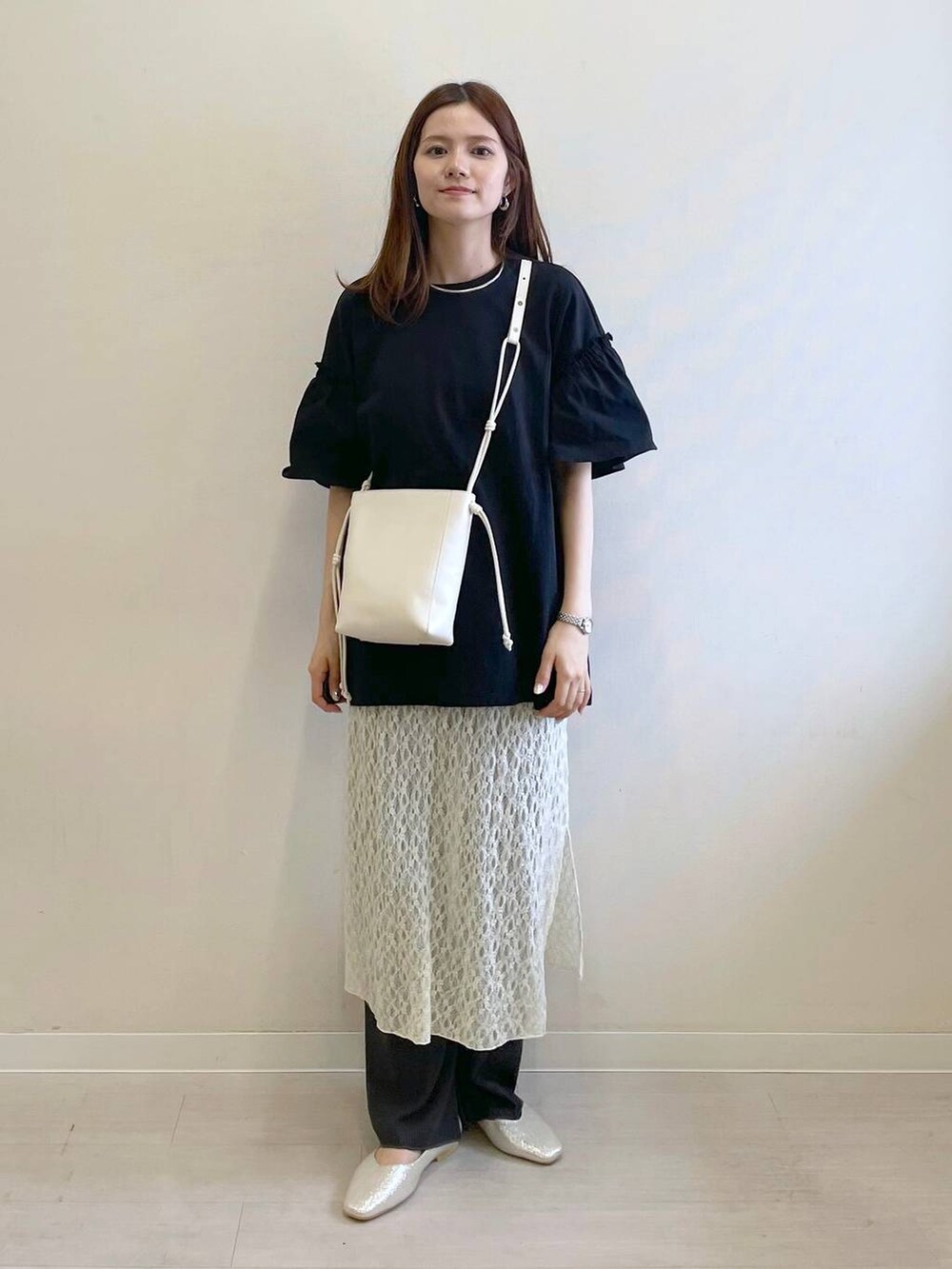 シルバー系のパンプス、ホワイト系のその他パンツ、ホワイト系のショルダーバッグを着用したレディースの春コーディネートの4枚目の写真