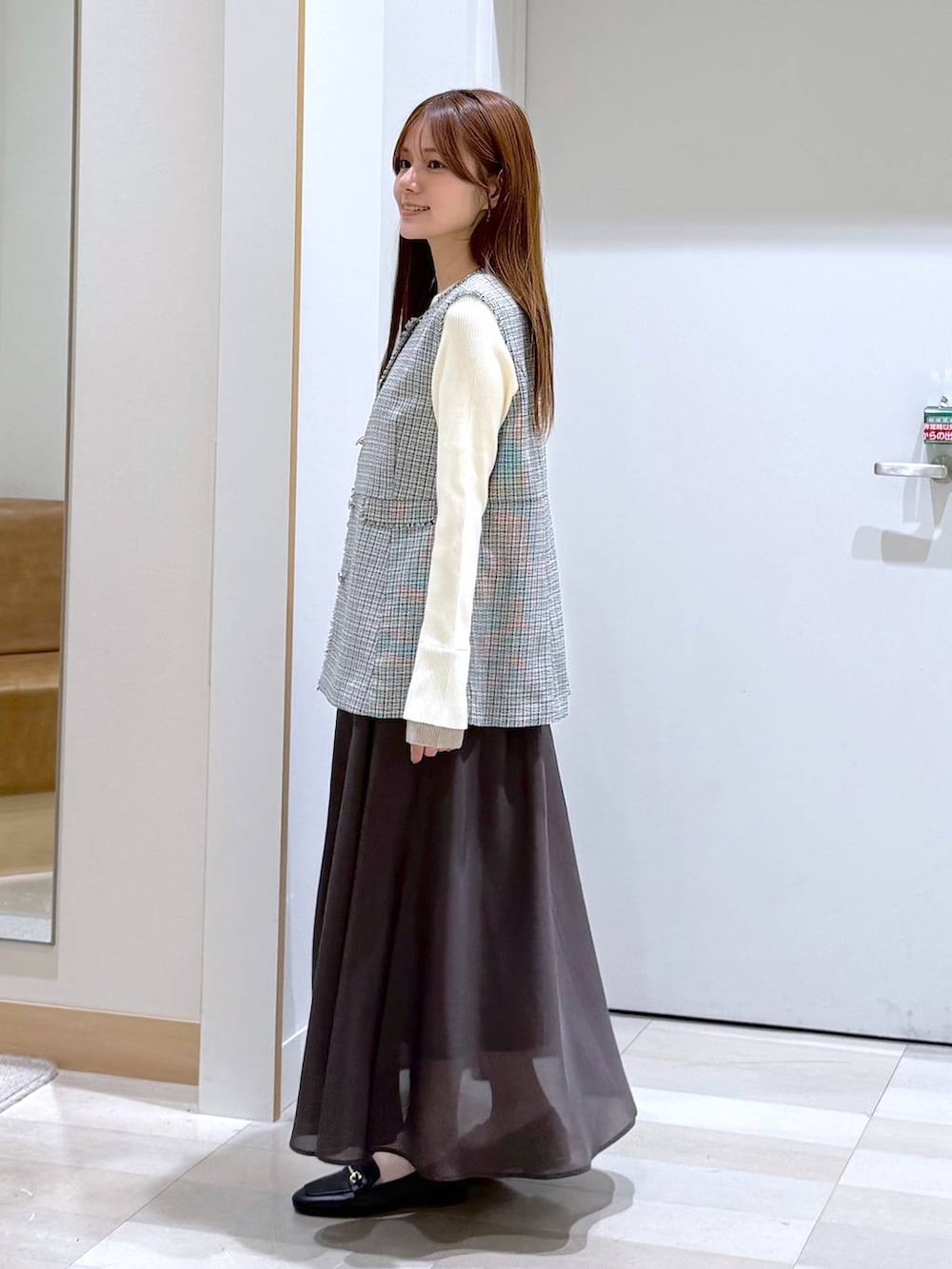 ブラック系のローファー、ブラック系のトートバッグ、ホワイト系のその他アウターを着用したレディースの春コーディネートの2枚目の写真