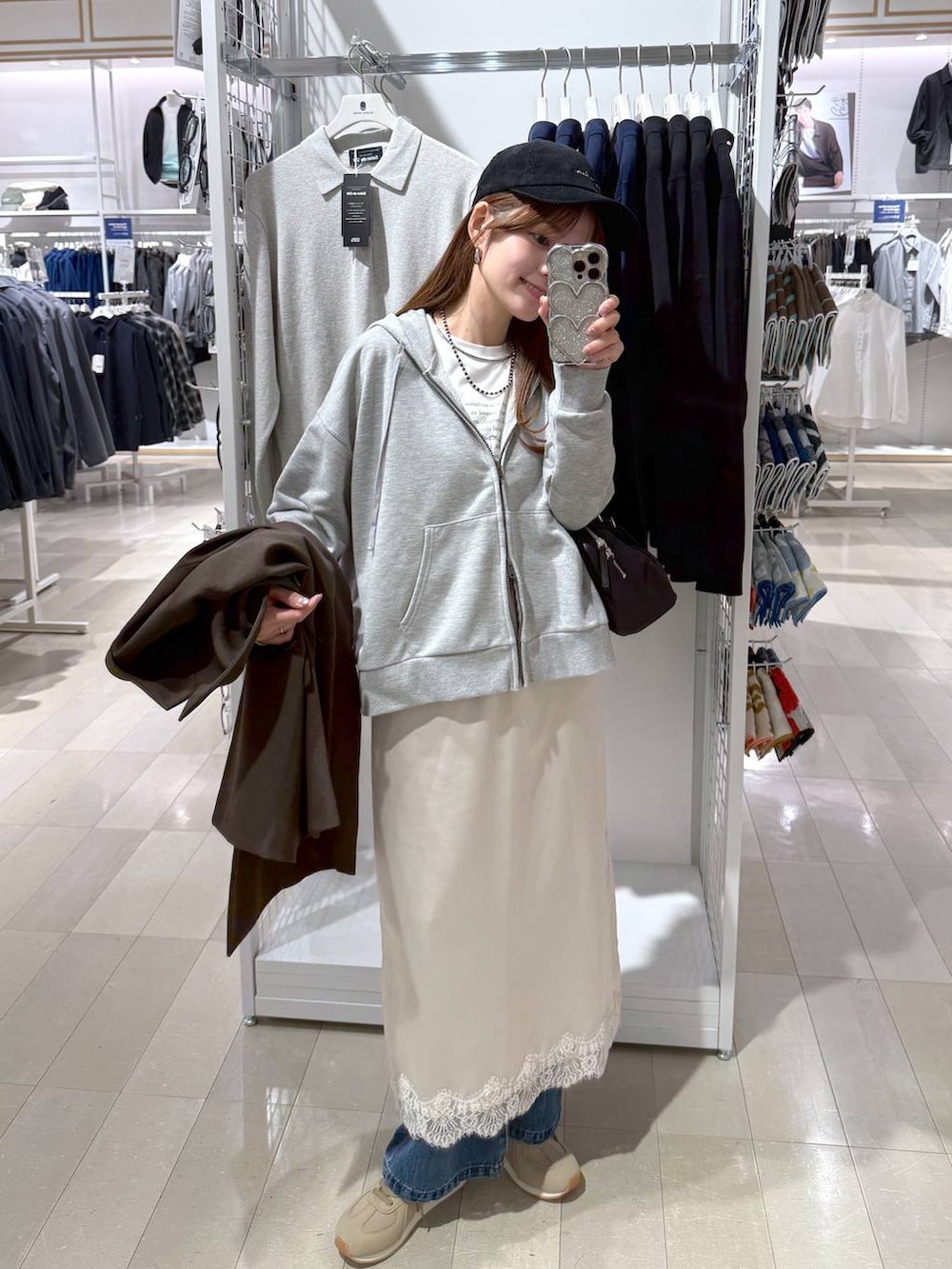 ブルー系のデニムパンツ、ベージュ系のスニーカー、ブラウン系のテーラードジャケットを着用したレディースの冬コーディネートの4枚目の写真