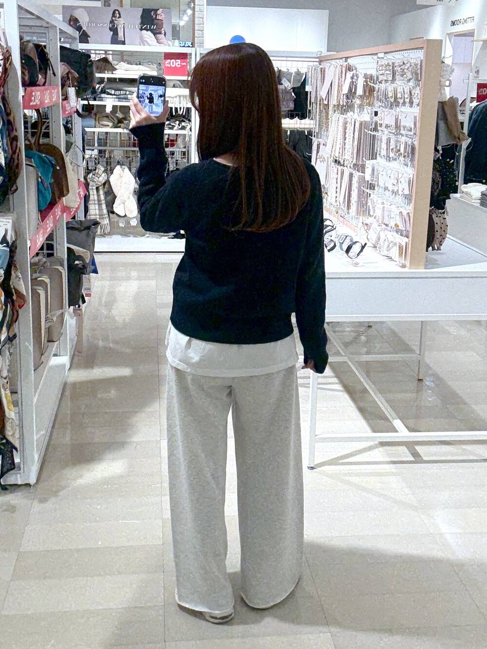 ホワイト系のTシャツ/カットソー、ブルー系のニット/セーター、ホワイト系のスウェットパンツを着用したレディースの冬コーディネートの3枚目の写真