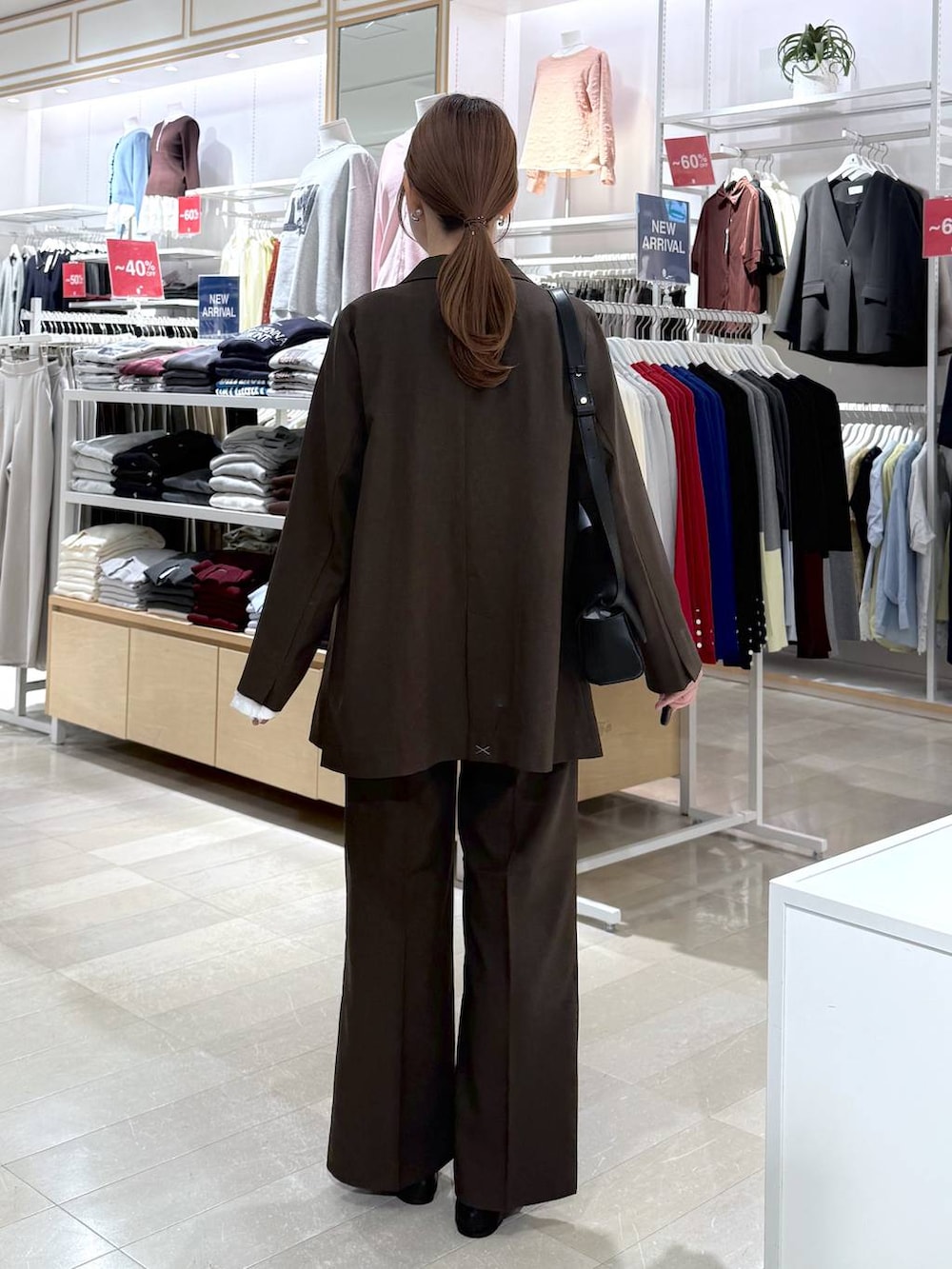 ブラック系のパンプス、ホワイト系のTシャツ/カットソー、ブラウン系のテーラードジャケットを着用したレディースの秋コーディネートの3枚目の写真