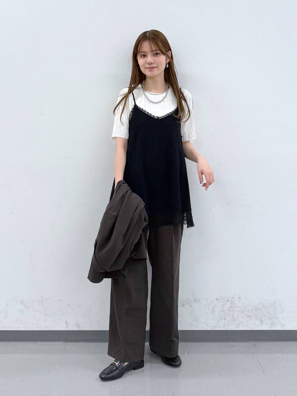 ブラック系のローファー、ブラック系のニット/セーター、ブラウン系のその他パンツを着用したレディースの春コーディネートの5枚目の写真