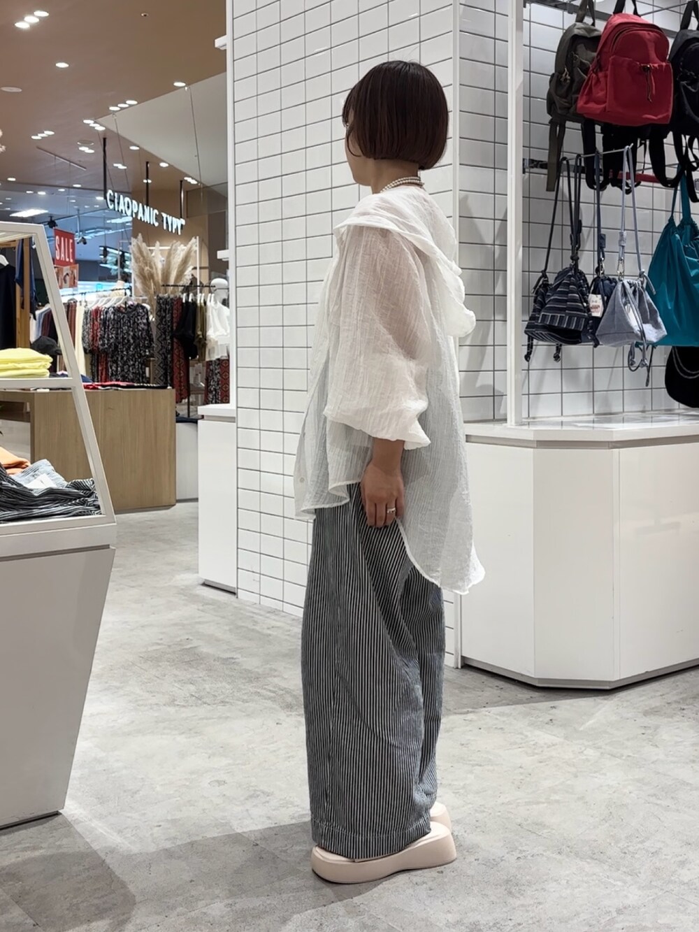 ホワイト系のサンダル、ブルー系のデニムパンツ、ホワイト系のシャツ/ブラウスを着用したレディースの夏コーディネートの3枚目の写真