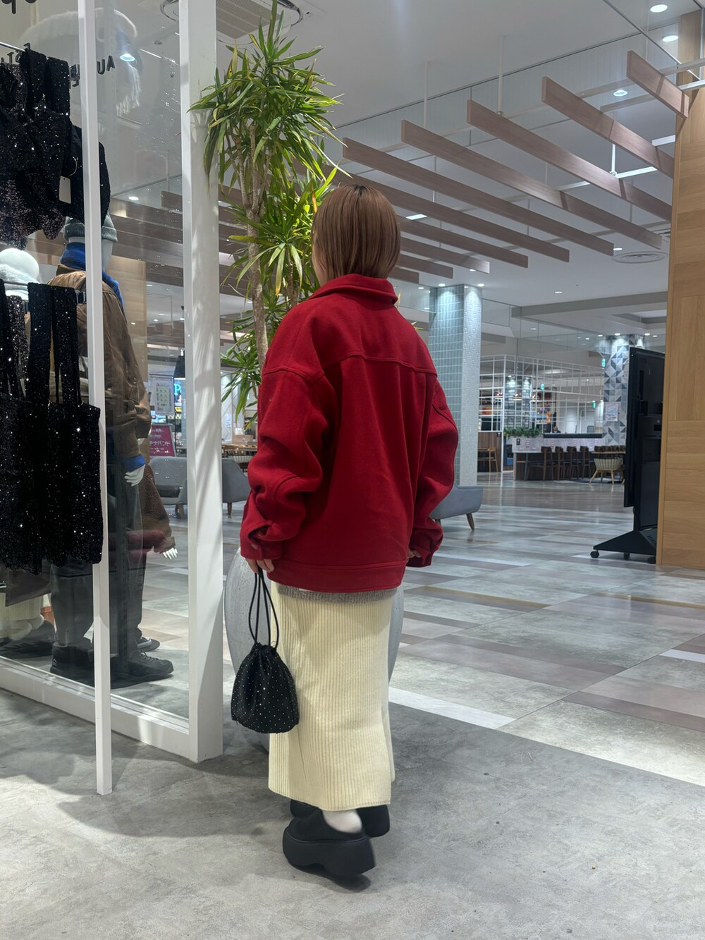 レッド系のその他アウター、ベージュ系のベスト、ホワイト系のスカートを着用したレディースの冬コーディネートの2枚目の写真