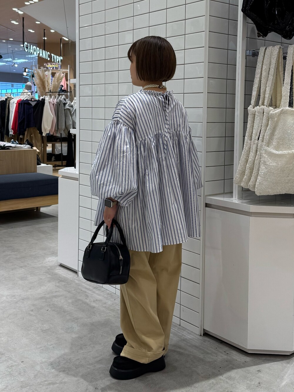 ブルー系のシャツ/ブラウス、ベージュ系のチノパンツ、ブラック系のサンダルを着用したレディースの春コーディネートの3枚目の写真