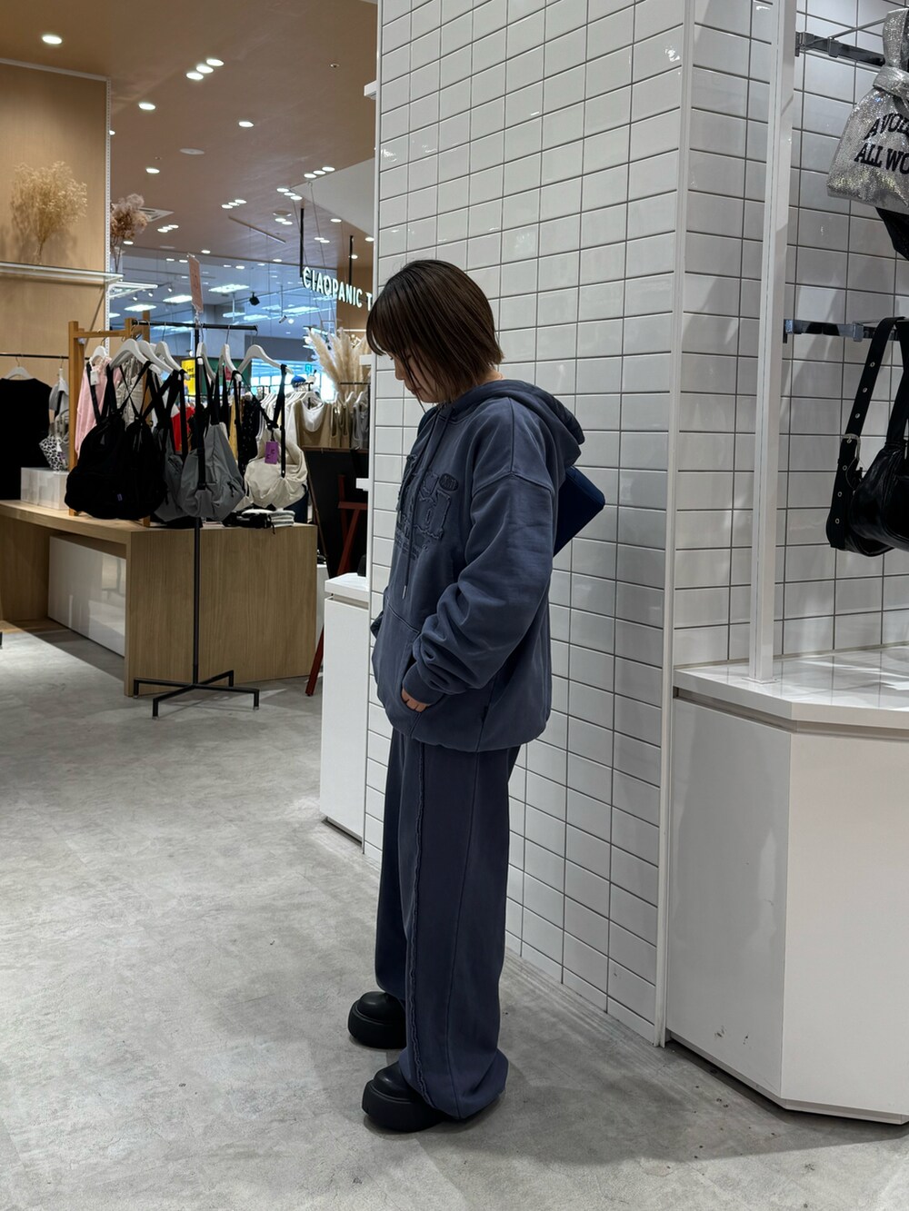 ブルー系のパーカー、ブルー系のその他パンツ、ブラック系のブーツを着用したレディースの春コーディネートの2枚目の写真