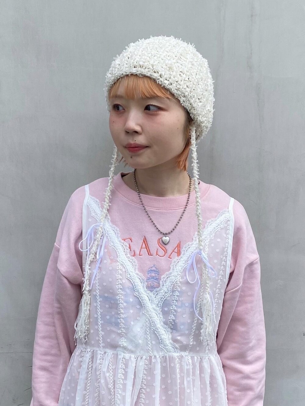 ピンク系のTシャツ/カットソー、ホワイト系のキャミソール、ブルー系のデニムパンツを着用したレディースの春コーディネートの2枚目の写真