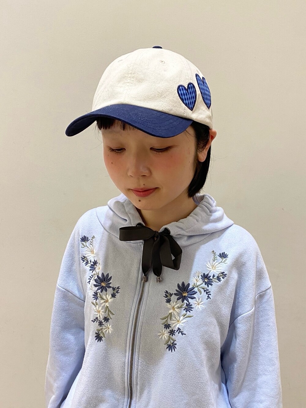 ベージュ系のキャップを着用したレディースの春コーディネートの2枚目の写真