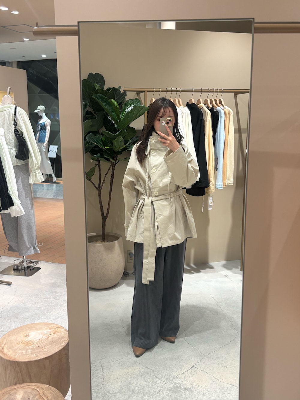 ホワイト系のトレンチコート、イエロー系のブーツを着用したレディースの春コーディネートの5枚目の写真