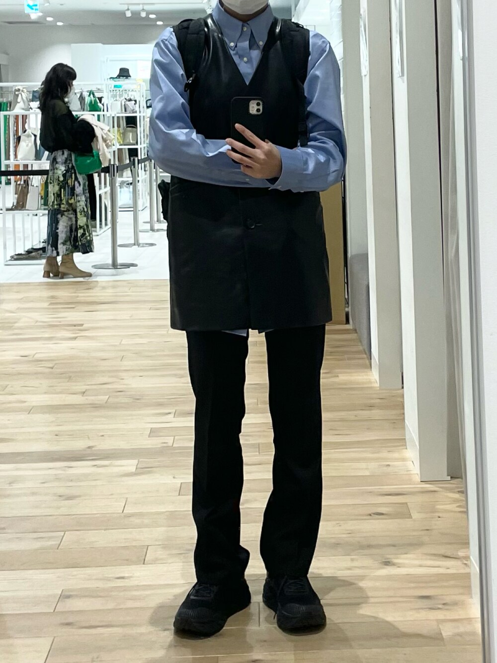 ブラック系のベスト、ブラック系のスラックス、ブラック系のスニーカーを着用したレディースの春コーディネートの4枚目の写真