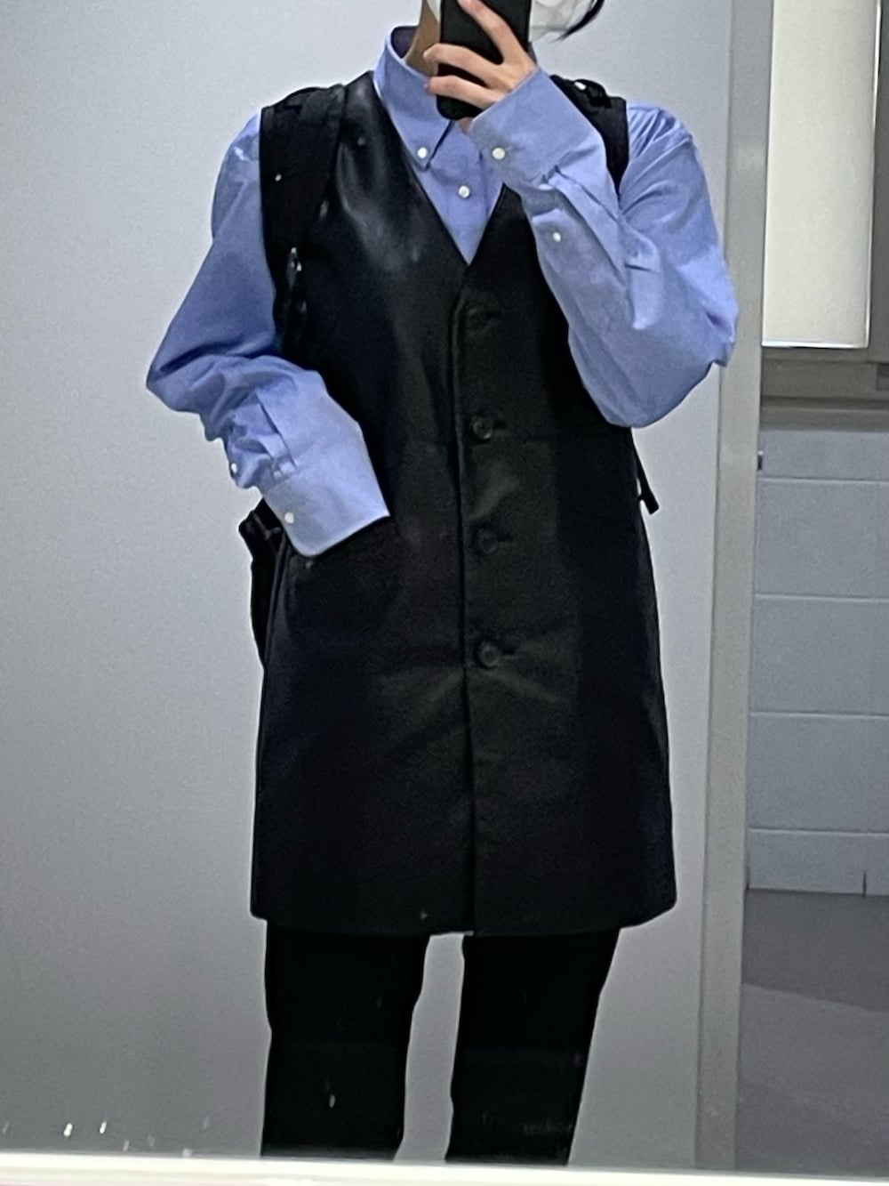 ブラック系のベスト、ブラック系のスラックス、ブラック系のスニーカーを着用したレディースの春コーディネートの5枚目の写真