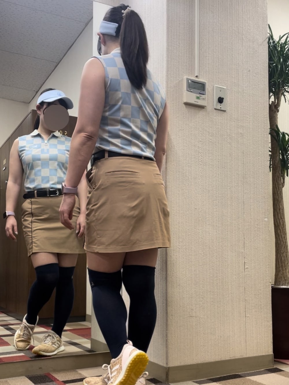 ブルー系のポロシャツ、ベージュ系のスカート、ブラック系のソックス/靴下を着用したレディースの夏コーディネートの2枚目の写真