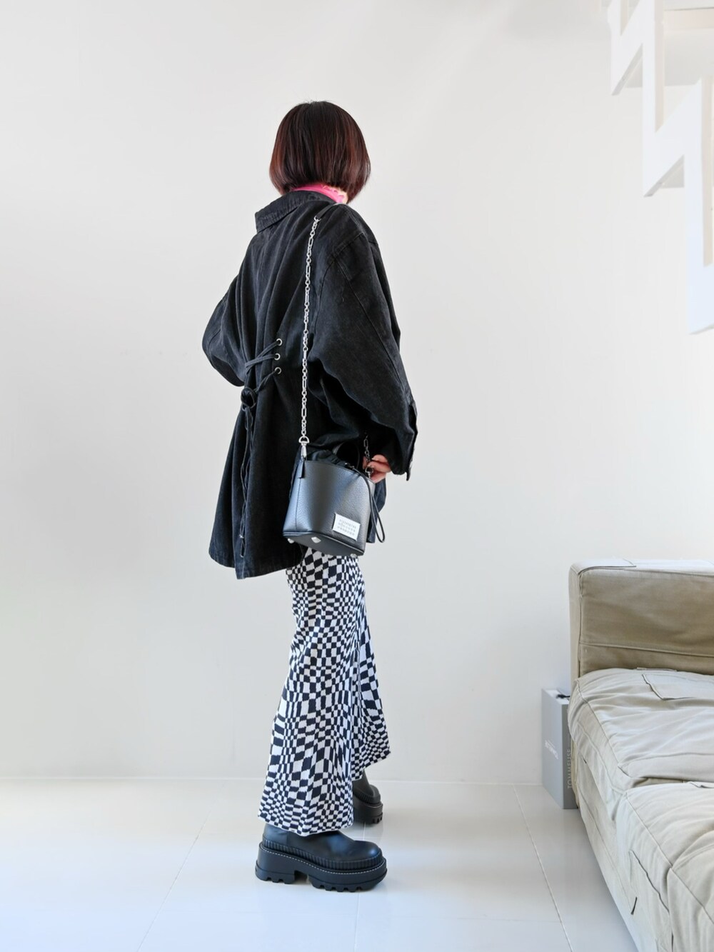 ブラック系のデニムジャケット、ピンク系のTシャツ/カットソー、ブラック系のその他パンツを着用したレディースの春コーディネートの2枚目の写真