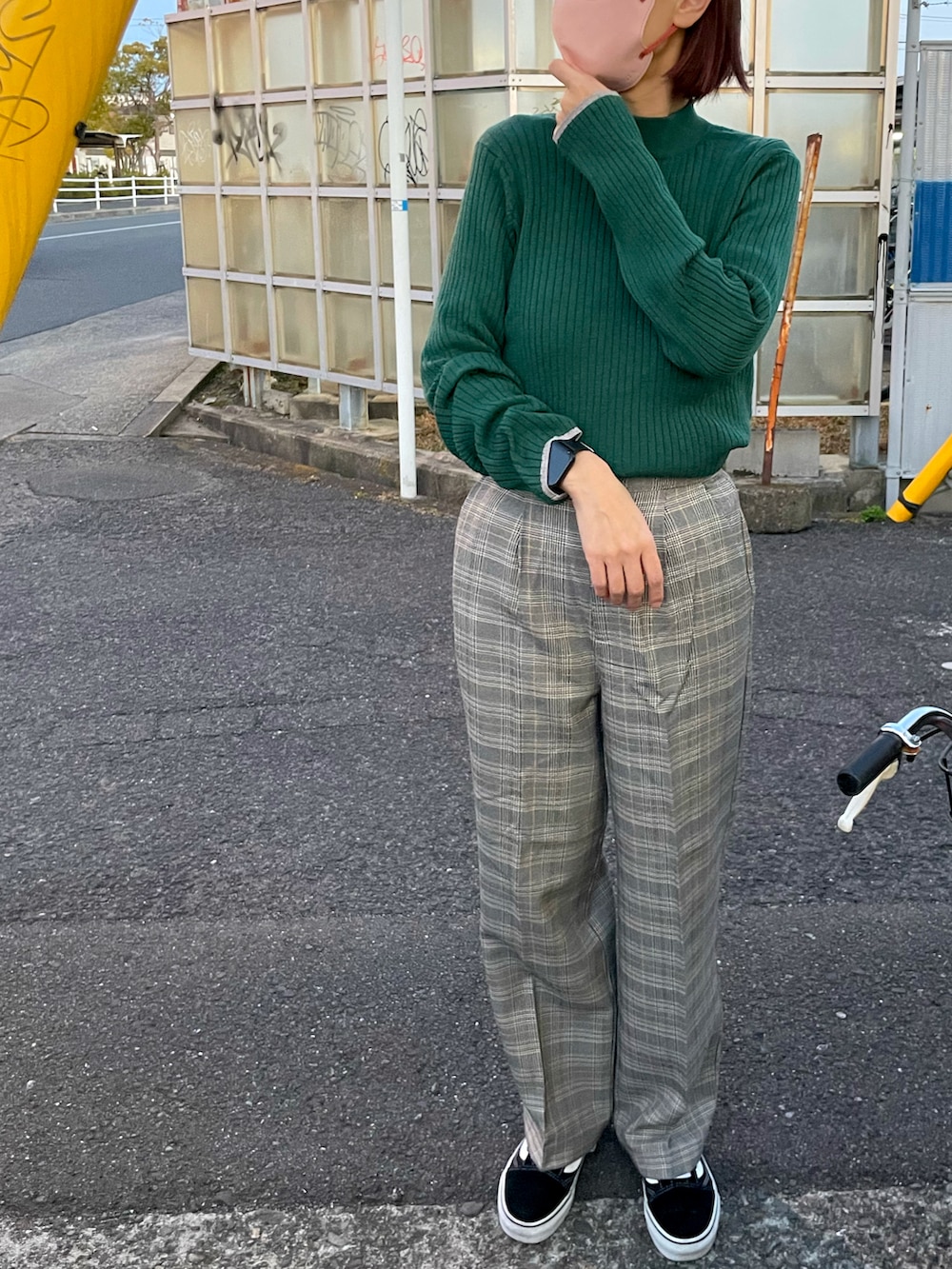 グリーン系のニット/セーター、グレー系のその他パンツ、ブラック系のスニーカーを着用したレディースの春コーディネートの2枚目の写真