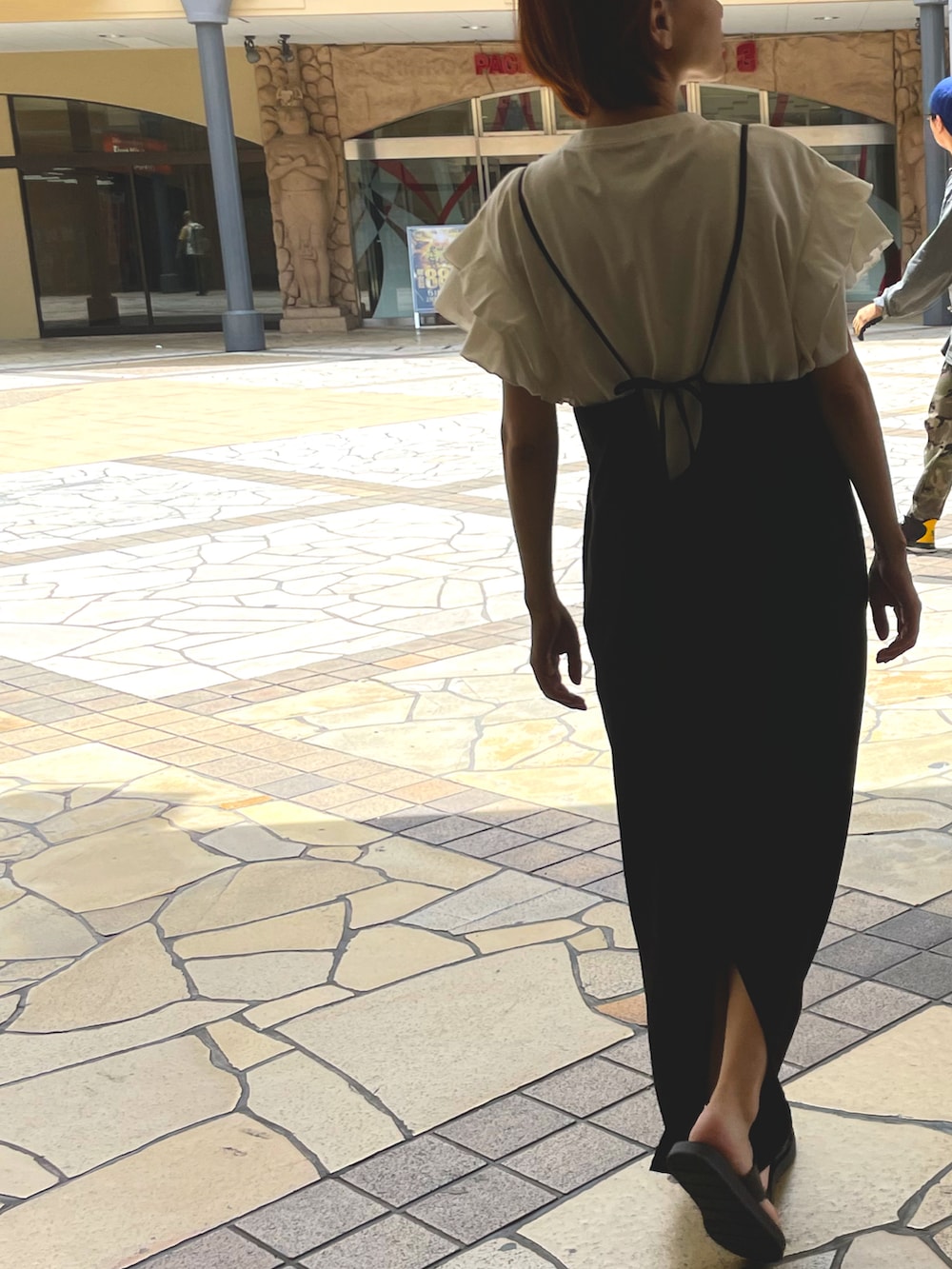 ホワイト系のトップス、ブラック系のサンダル、ブラック系のワンピースを着用したレディースの夏コーディネートの2枚目の写真