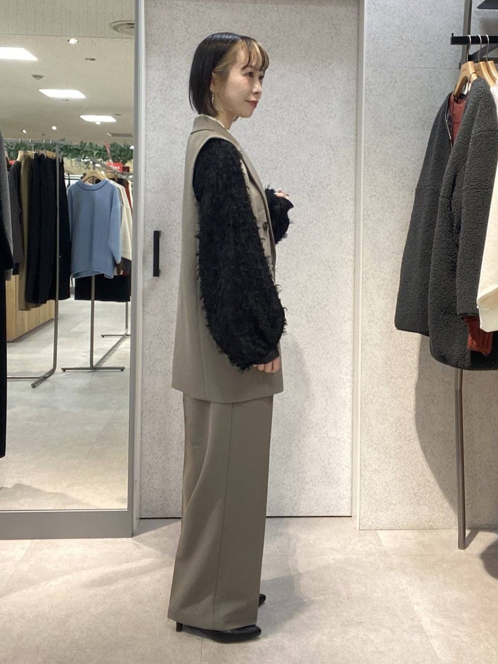 ブラウン系のその他パンツ、ブラウン系のその他アウター、ブラック系のシャツ/ブラウスを着用したレディースの冬コーディネートの2枚目の写真