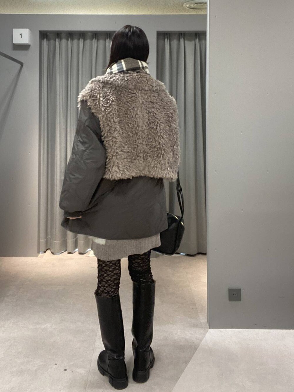 ブラック系のブーツ、ブラック系のショルダーバッグ、グレー系のニット/セーターを着用したレディースの秋コーディネートの3枚目の写真