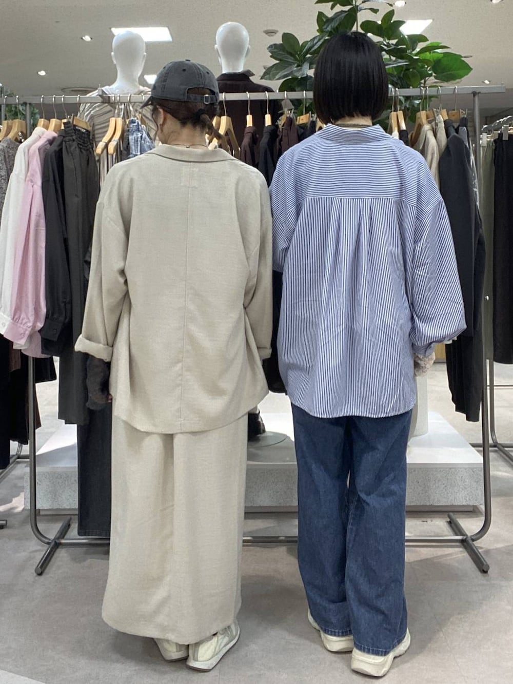 ブルー系のシャツ/ブラウス、ブルー系のデニムパンツ、ベージュ系のスカートを着用したレディースの春コーディネートの3枚目の写真