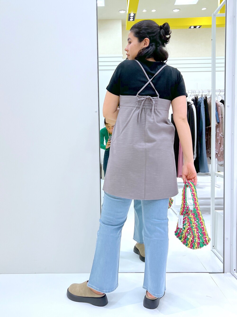 その他のハンドバッグ、グレー系のワンピース、ブルー系のデニムパンツを着用したレディースの春コーディネートの2枚目の写真