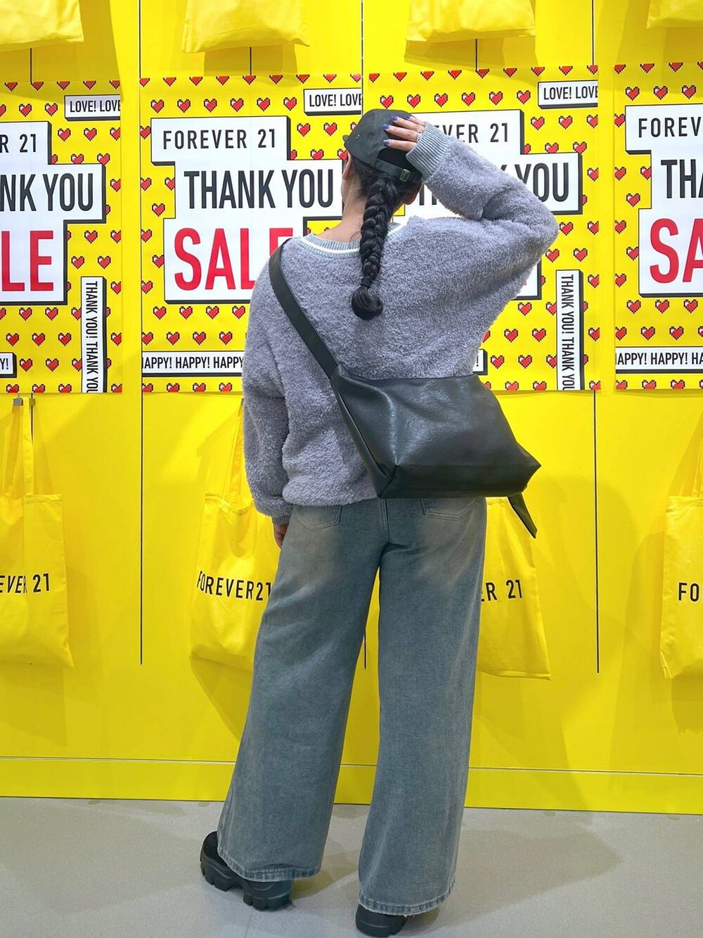 グレー系のニット/セーター、ブルー系のデニムパンツ、ブラック系のモカシン/デッキシューズを着用したレディースの秋コーディネートの3枚目の写真