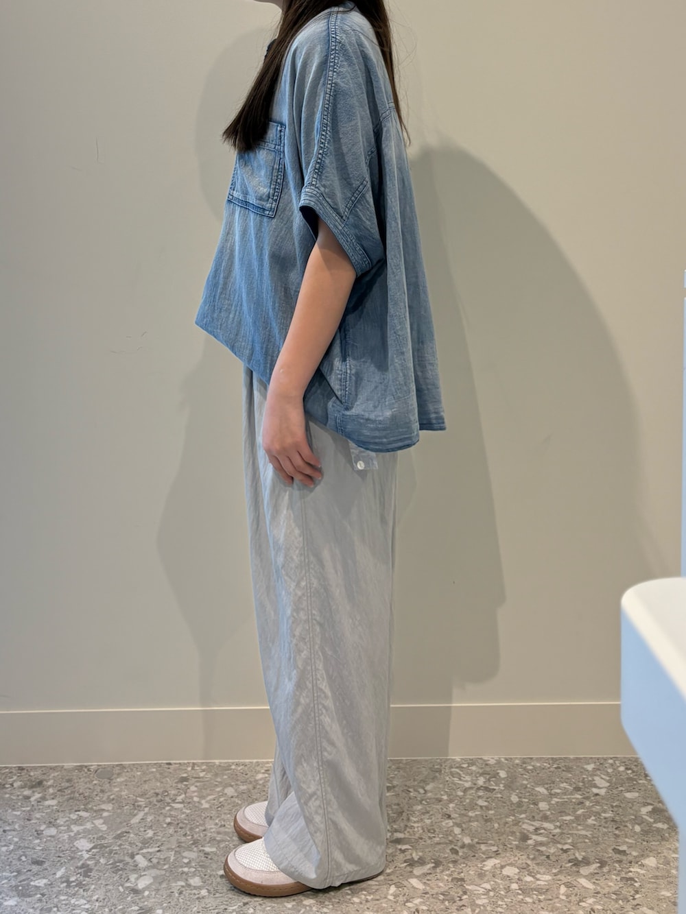 グレー系のその他パンツ、ブルー系のシャツ/ブラウス、ホワイト系のTシャツ/カットソーを着用したレディースの春コーディネートの4枚目の写真