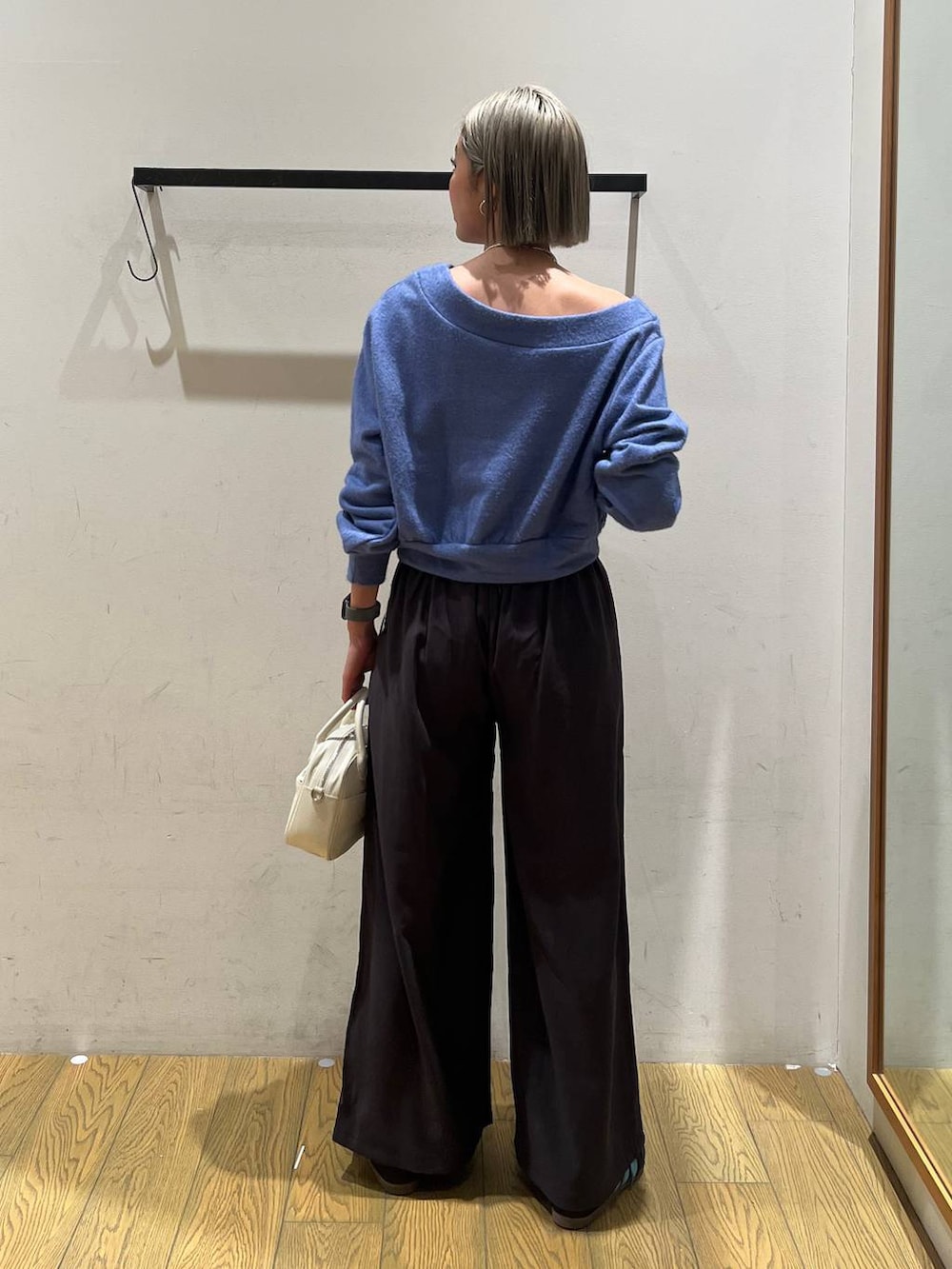 ホワイト系のハンドバッグ、ブルー系のTシャツ/カットソー、グレー系のその他パンツを着用したレディースの冬コーディネートの4枚目の写真