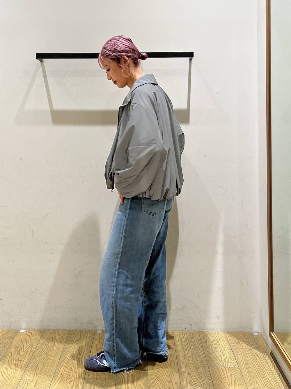 ブルー系のデニムパンツ、グレー系のTシャツ/カットソー、シルバー系のブルゾンを着用したレディースの夏コーディネートの2枚目の写真