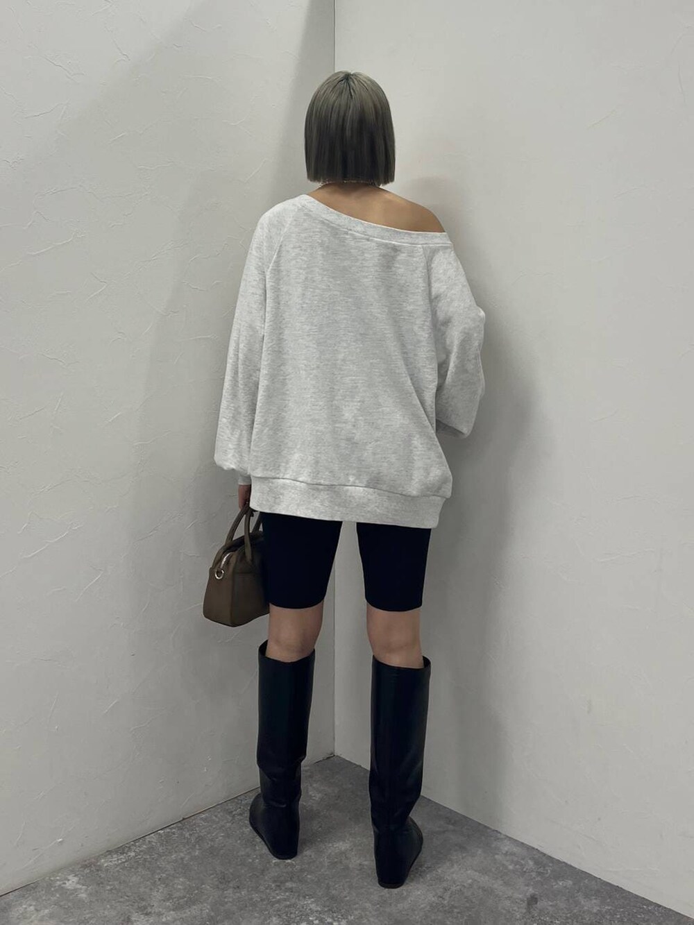 ブラック系のブーツ、ブラウン系のハンドバッグ、ブラック系のその他パンツを着用したレディースの冬コーディネートの4枚目の写真