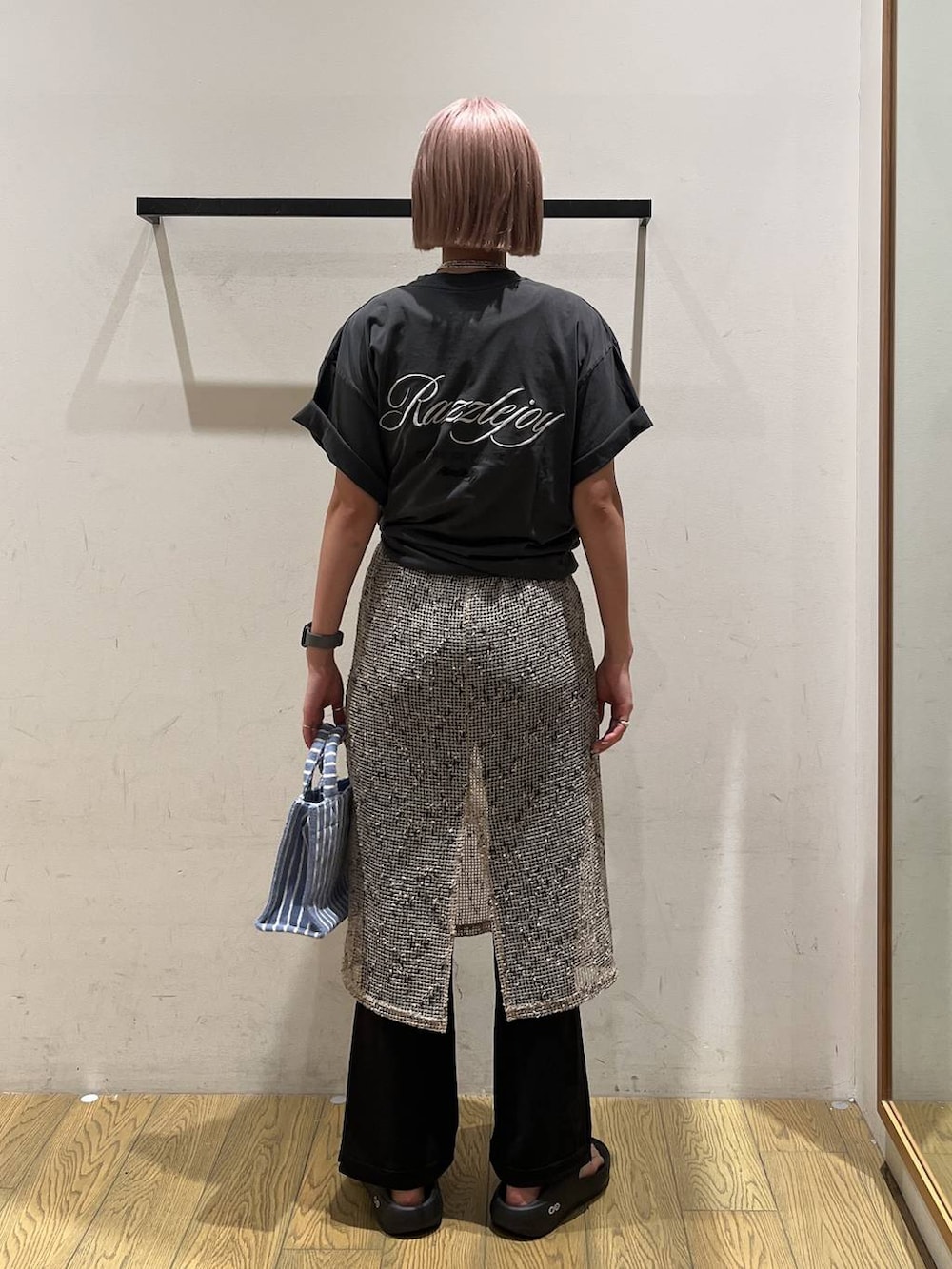 ブルー系のトートバッグ、ブラック系のサンダル、ベージュ系のワンピースを着用したレディースの夏コーディネートの4枚目の写真
