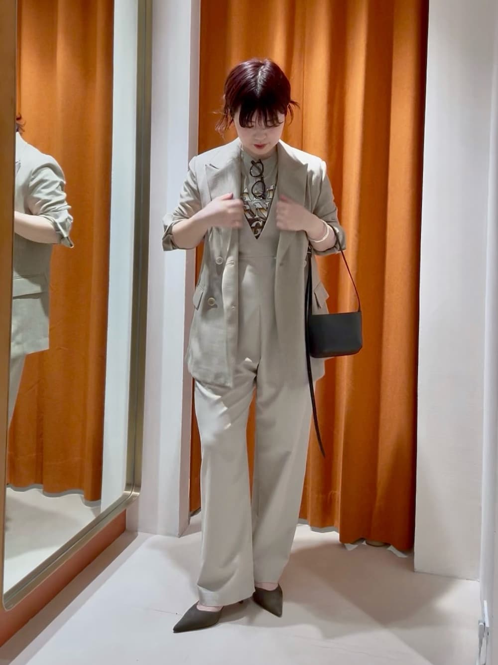 ベージュ系のテーラードジャケット、ベージュ系のつなぎ/オールインワン、ブラウン系のパンプスを着用したレディースの春コーディネートの2枚目の写真