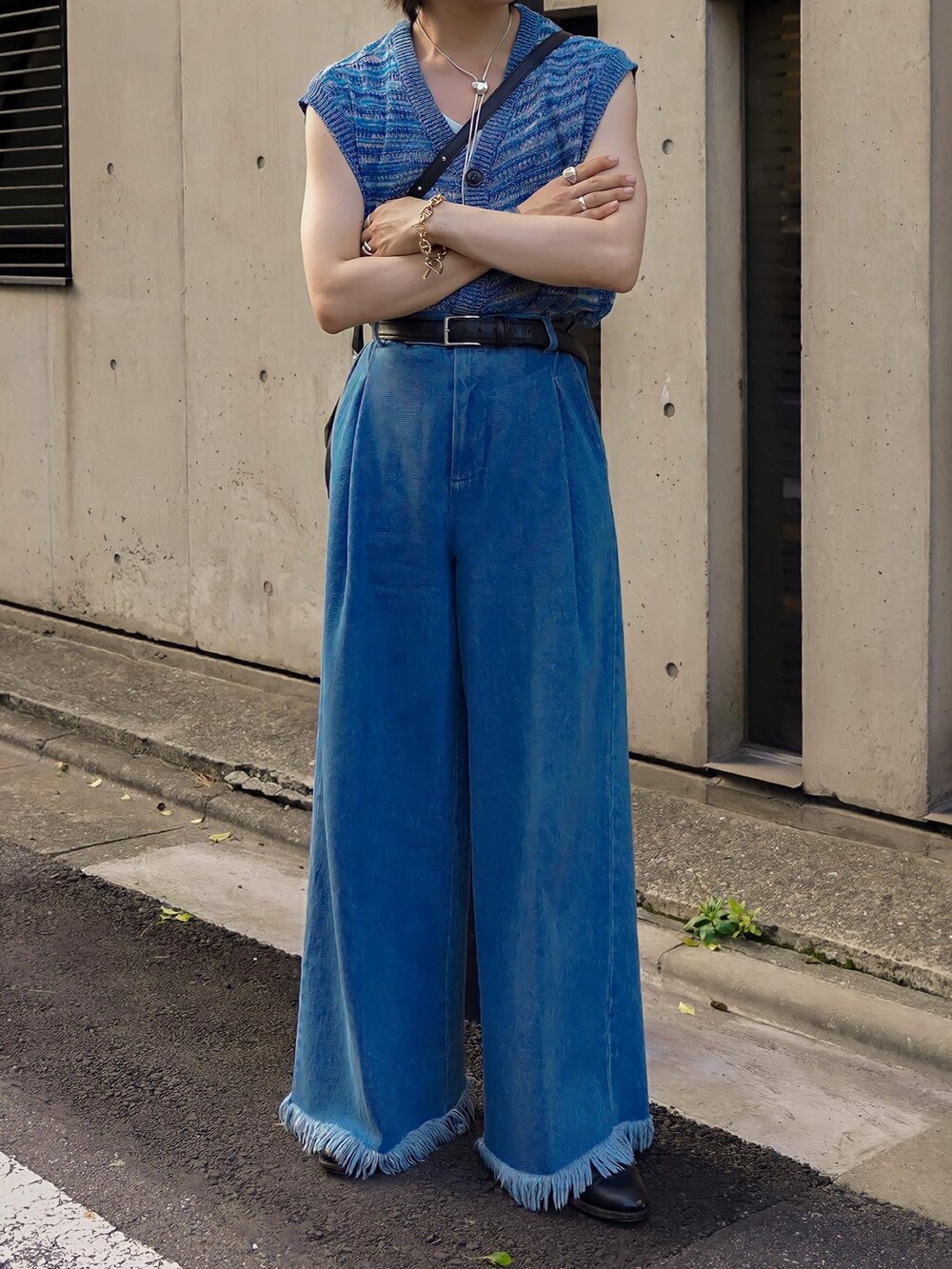 ブルー系のデニムパンツ、ブラック系のブーツ、ブルー系のベストを着用したメンズの夏コーディネートの3枚目の写真