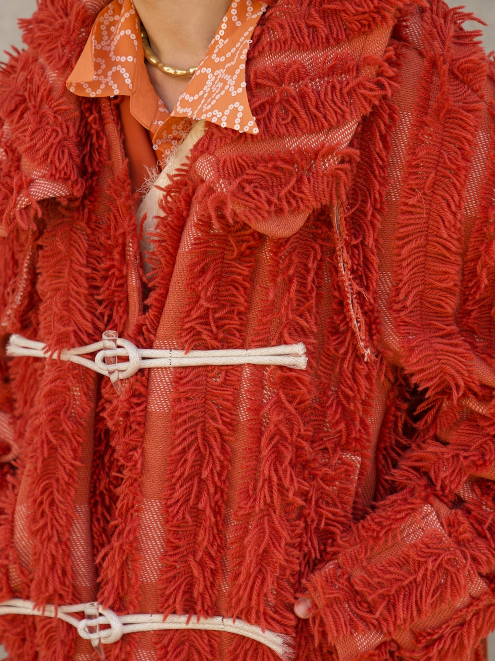 ホワイト系のショルダーバッグ、オレンジ系のその他パンツ、オレンジ系のジャケット/アウターを着用したメンズの春コーディネートの4枚目の写真