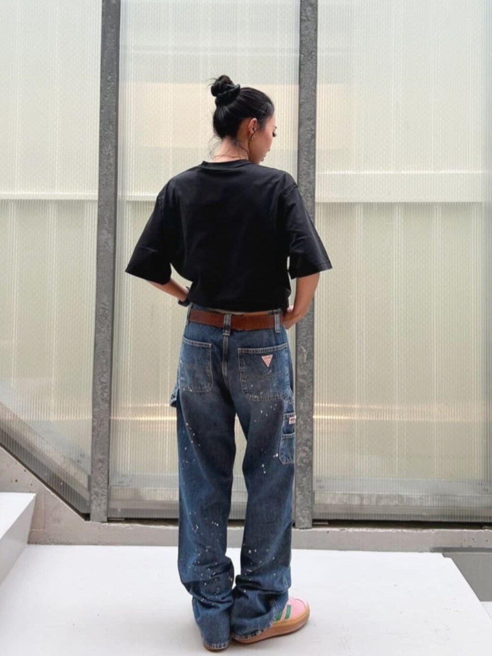 ブルー系のデニムパンツ、ブラック系のTシャツ/カットソーを着用したレディースの秋コーディネートの2枚目の写真