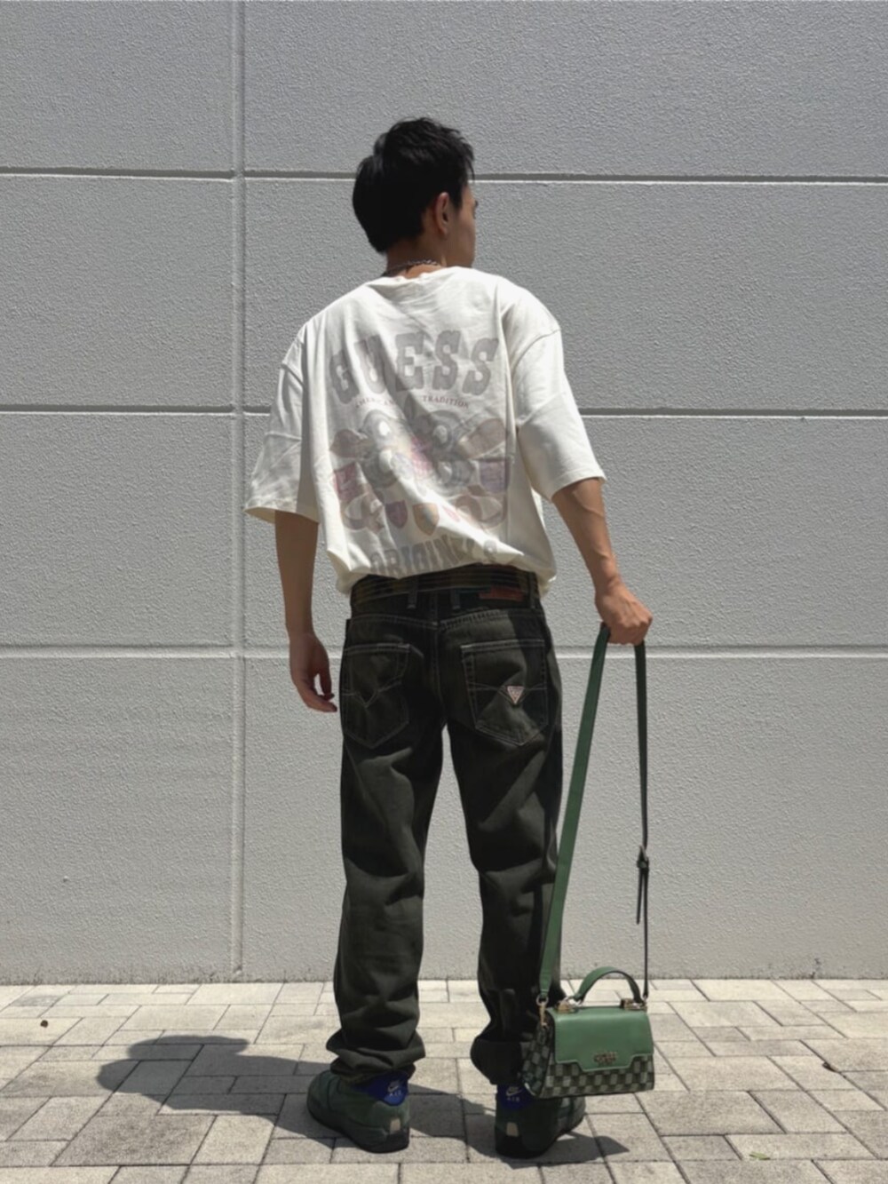 グリーン系のハンドバッグを着用したメンズの夏コーディネートの2枚目の写真