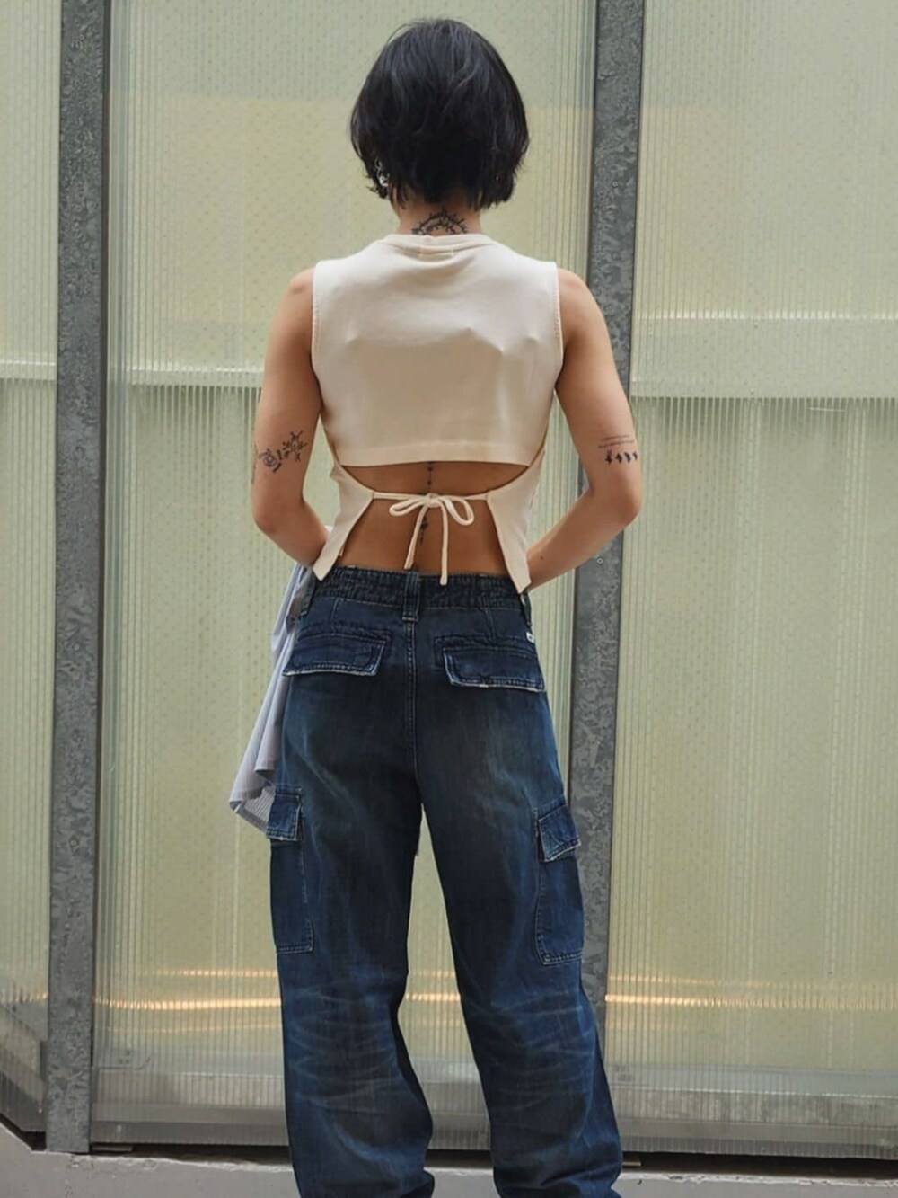 ホワイト系のTシャツ/カットソー、グレー系のシャツ/ブラウス、ブルー系のデニムパンツを着用したレディースの秋コーディネートの6枚目の写真