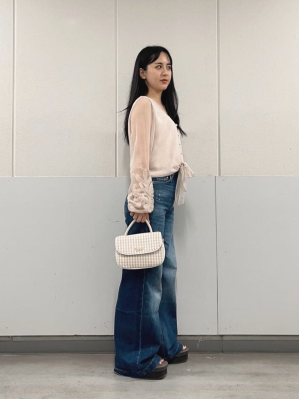 ベージュ系のシャツ/ブラウス、ホワイト系のショルダーバッグ、ブルー系のデニムパンツを着用したレディースの秋コーディネートの3枚目の写真