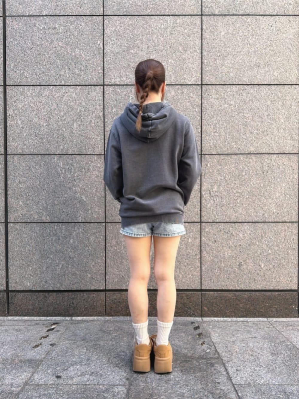 グレー系のパーカー、ブルー系のデニムパンツを着用したレディースの冬コーディネートの3枚目の写真